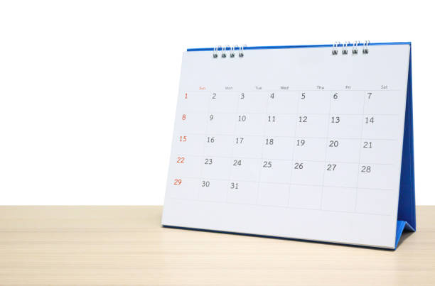 istock White desk calendar on wood table top isolated on white background 1284822190