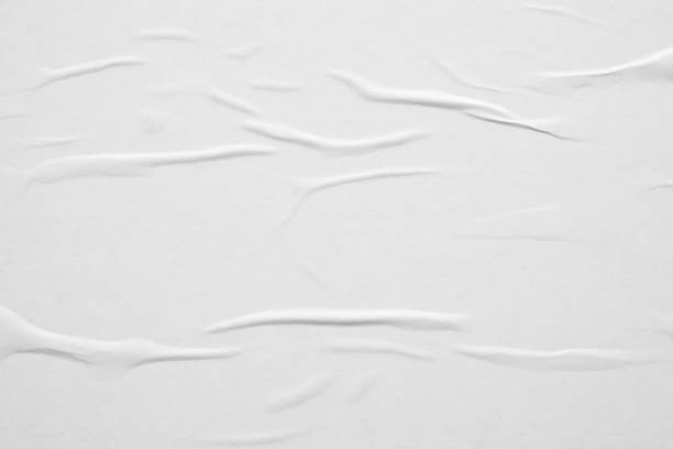 istock Blank white crumpled and creased paper poster texture background 1284822927