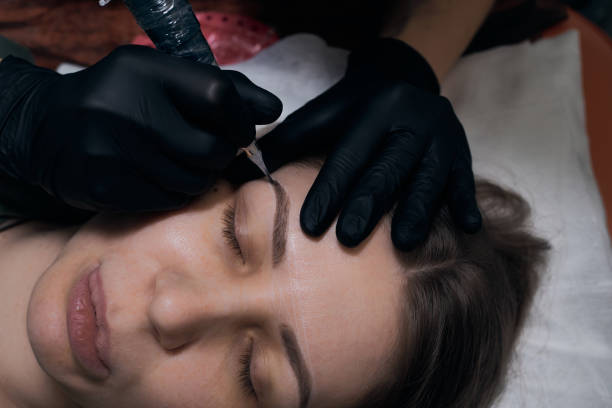 istock Permanent eyebrow makeup procedure. Eyebrow tattooing, process. The use of tools by a master for permanent eyebrow makeup. 1284823048