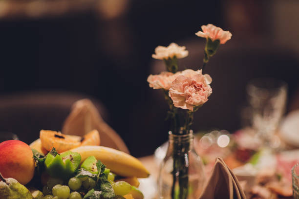 Top view of plate, fork and knife decorated with flowers on party wedding.