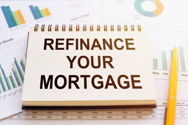 istock Refinance your mortgage - written on notepad on financial charts and graphs with yellow pen 1284825338