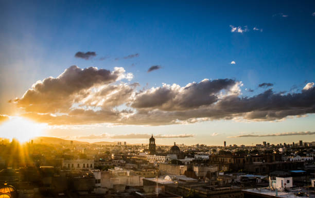 Urban view from Guadalajara city, blue and cloudy sky, sunset landscape