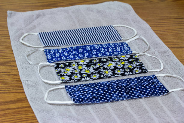 istock Hand washed face masks drying on a cloth towel 1284827617