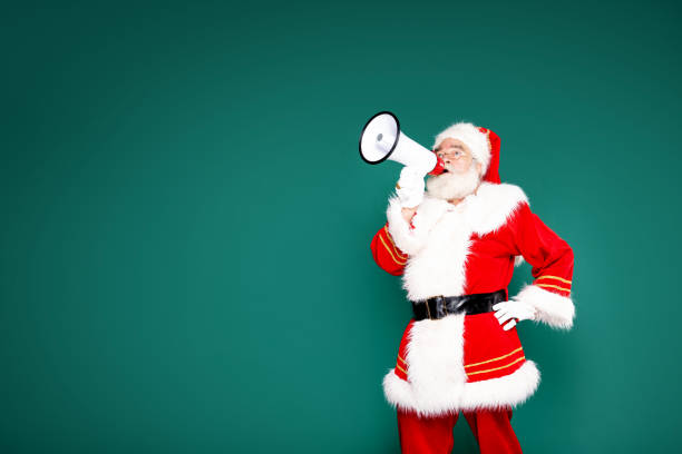 istock Authentic Santa Claus with white beard screaming through megaphone 1284828409