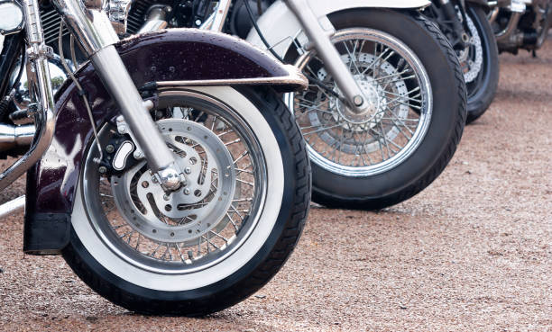 istock Wheels of motorbikes standing in a row close up 1284840970