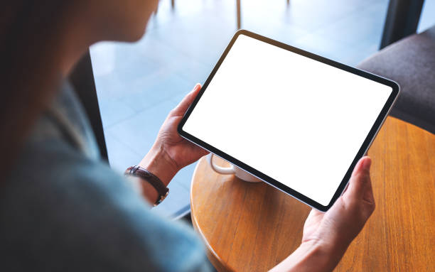 istock a woman holding digital tablet with blank white desktop screen 1284845203