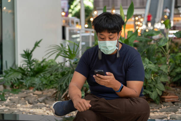 MS Arabic-Chinese man checking a small smartphone stock photo