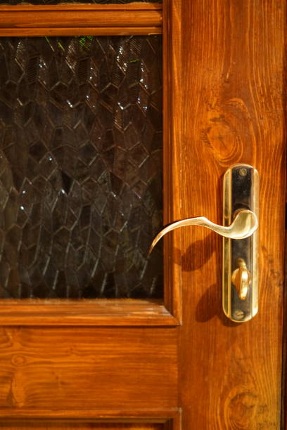 istock A closed wooden door and a gold handle. 1284851692