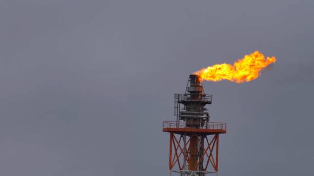 istock Fire Burning on Top of Gas Flare Stack Chimney in Petroleum Refinery Slow Motion 1284854924