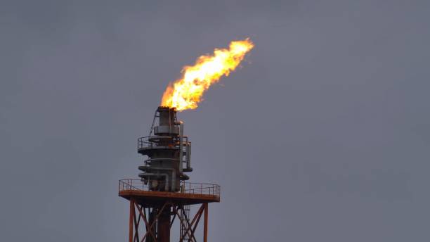 istock Fire Burning on Top of Gas Flare Stack Chimney in Petroleum Refinery Slow Motion 1284854946