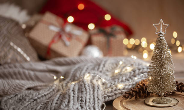 istock Christmas background with a small decorative Christmas tree in the foreground. Festive comfort concept. 1284857633