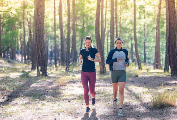 istock Beautiful female athletes jogging in the forest. 1284857802