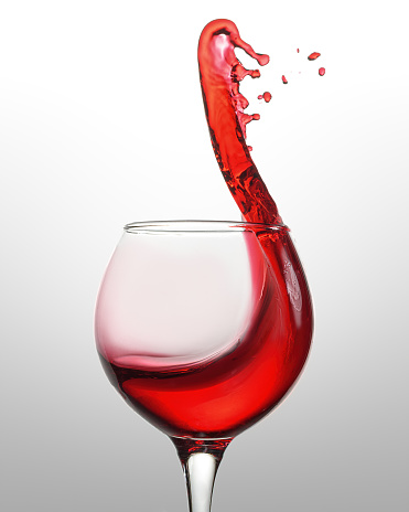 Spilled red wine from glass isolated on white background
