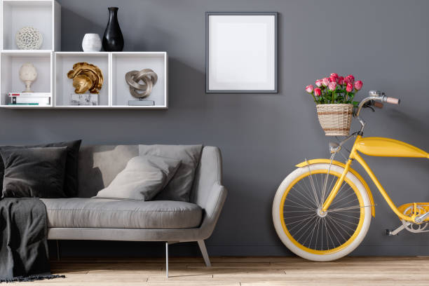 sofá gris con bicicleta amarilla en la sala de estar y marco vacío colgando en la pared - loft apartment living room sofa vehicle interior fotografías e imágenes de stock