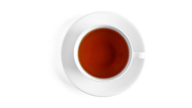 istock White cup with tea on saucer on a white background. View from the top 1284859985