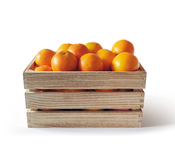 istock Fresh oranges in a wooden box, isolated from the white background 1284862228