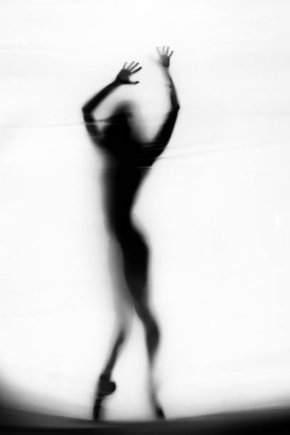 istock Ballerina dancing behind the curtain 1284863731