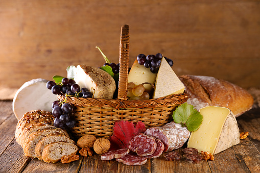 wicker basket with cheese and salami