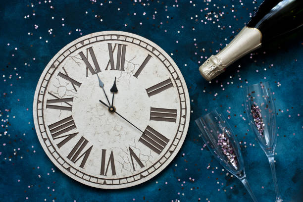istock Champagne bottle and glasses  with Christmas  clock. Flat lay 1284865782