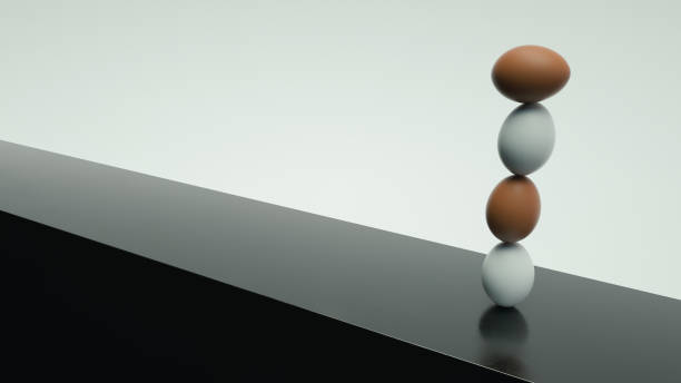istock Eggs Standing On Top Of Each Other On The Reflective Metal Surface And White Background 1284868628