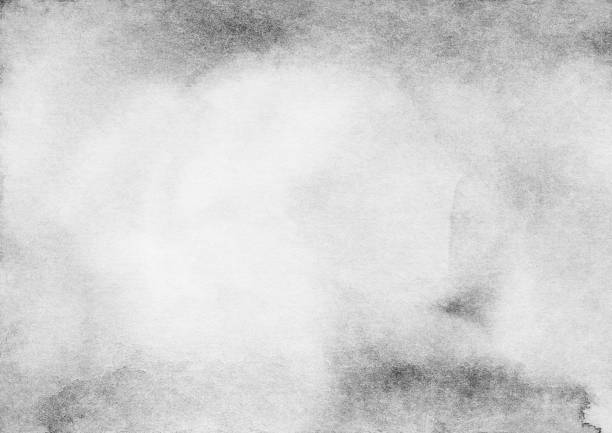 istock Watercolor light gray background texture. Monochrome backdrop with space for text. Grey stains on paper overlay. 1284873721