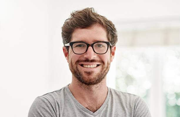 Happy to have a place I can call home Portrait of a confident and happy young man at home 35 39 years stock pictures, royalty-free photos & images