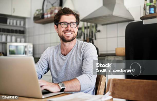 Staying In The Know From The Comfort Of Home Stock Photo - Download Image Now - Men, Laptop, Domestic Life