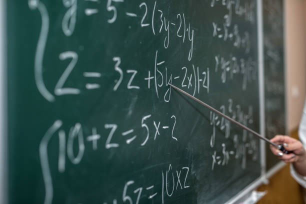 istock female hand showing math formula in chalkboard. Back to school 1284874714