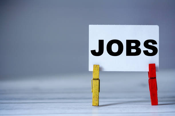 istock Reminder sticky note with clothes pin on table. Sticky note with word JOBS. Search job 1284877726