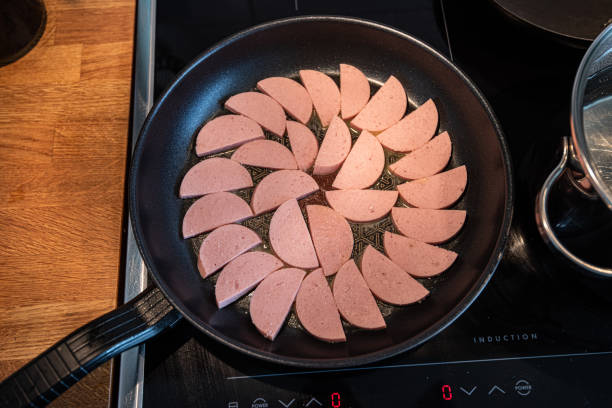 istock Fresh falukorv in a frying pan.. 1284878321