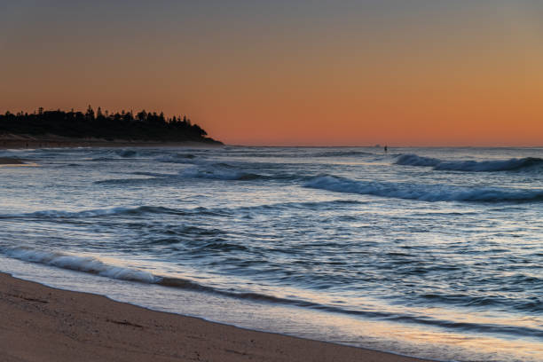 istock Clear skies and small waves, dawn at the beach 1284879253