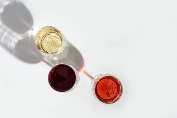 istock Three wine glasses wirh red, rose and white wine with dark shadow. 1284879485