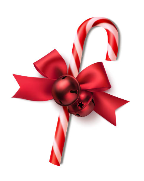 istock Decorative candy cane with red bow and bells isolated on white. Christmas or New Year decoration. 1284879525