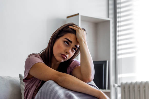 istock Lonely sad young women sitting at home. 1284880513