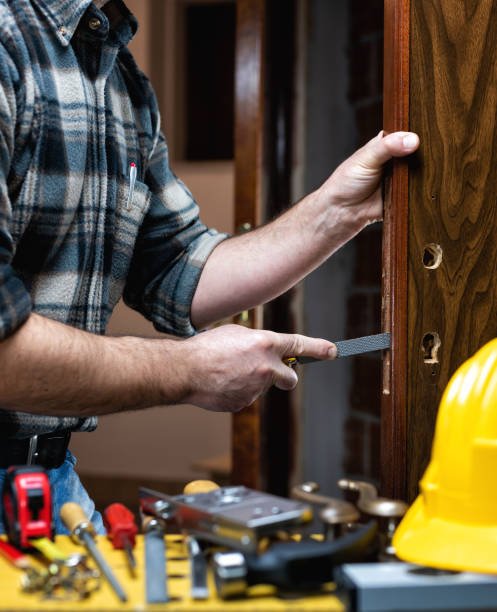 istock Carpenter at work repairs and installs the door lock. Carpentry. 1284880854