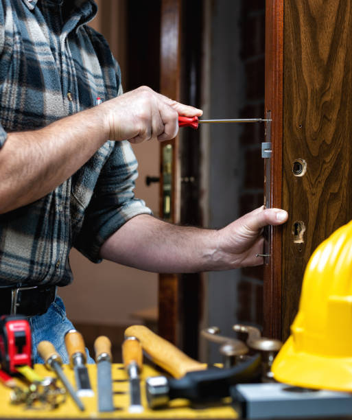 istock Carpenter at work repairs and installs the door lock. Carpentry. 1284880856