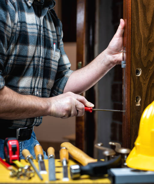 istock Carpenter at work repairs and installs the door lock. Carpentry. 1284880857