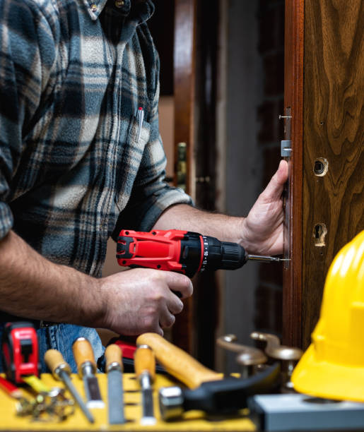 istock Carpenter at work repairs and installs the door lock. Carpentry. 1284880858