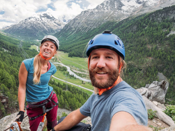 istock Happy couple taking selfie on Via Ferrata in summer 1284883626