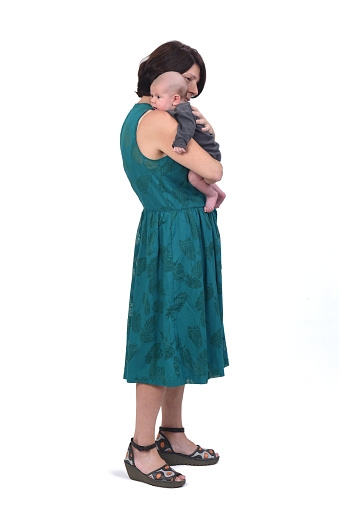 side view of  full portrait of a mother with her baby on white background