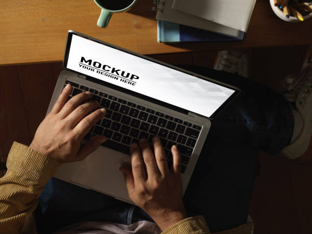 istock Male hands typing on laptop keyboard on his lap while sitting at workplace, clipping path 1284885941