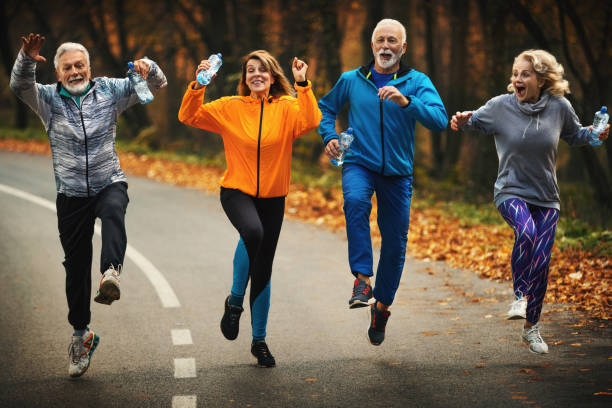 istock Group of mature folks jogging in a forest. 1284889680