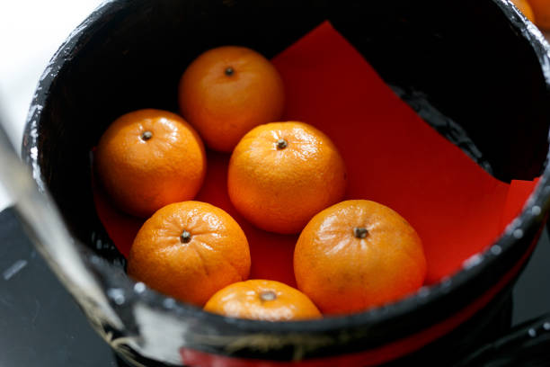 High angle view of Chinese mandarin oranges in a traditional basket.