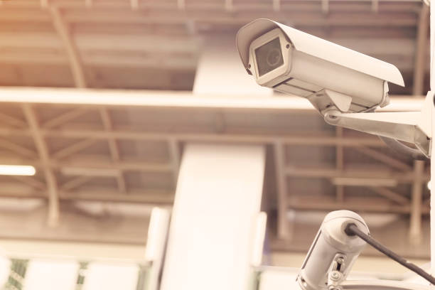 istock Security cctv camera or surveillance system on the white wall. CCTV on the white wall at the parking lot. 1284889930