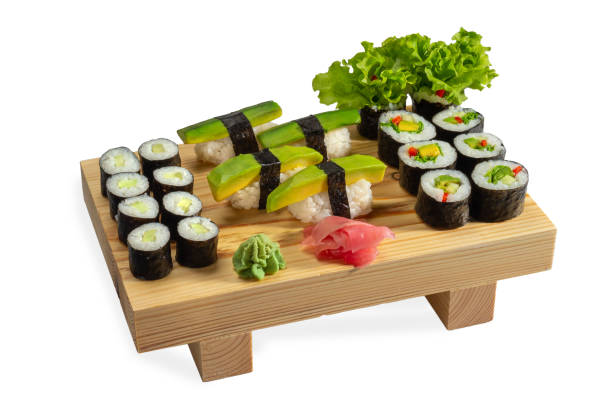 istock Sushi avocado set and sushi rolls on a wooden board 1284894299