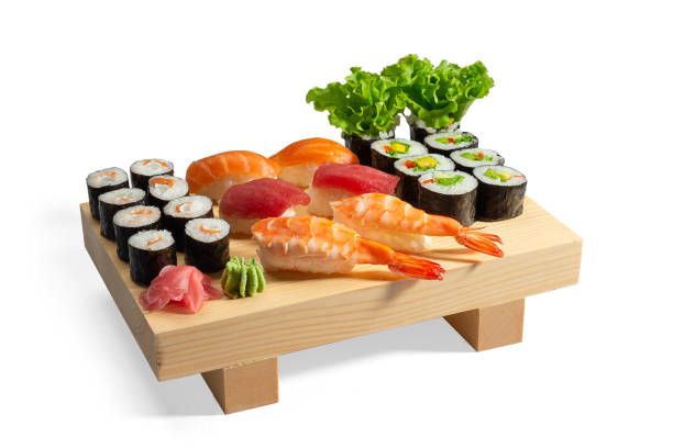 Sushi set and sushi rolls on a wooden board