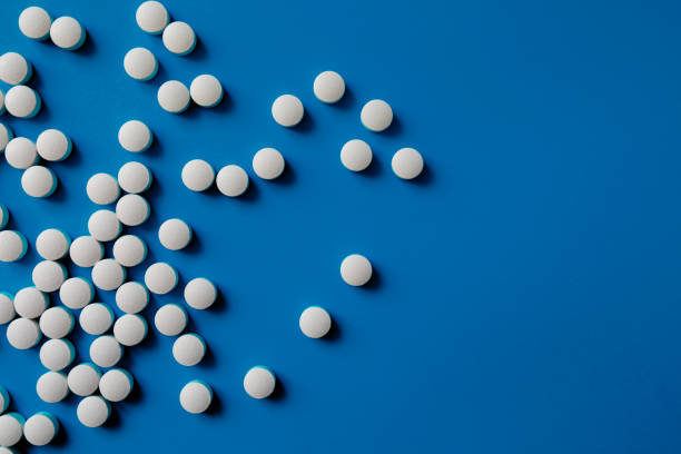 istock Assorted pharmaceutical medicine pills, tablets and capsules.Pills background. Heap of assorted various medicine tablets and pills different colors 1284896966
