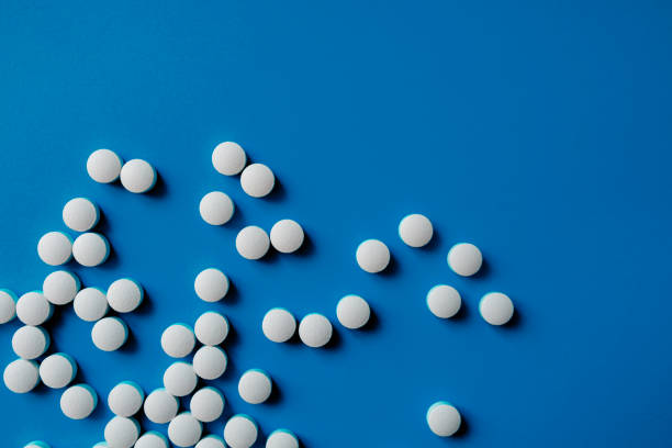 istock Assorted pharmaceutical medicine pills, tablets and capsules.Pills background. Heap of assorted various medicine tablets and pills different colors 1284896990