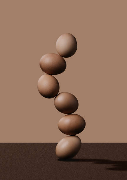 istock hen's eggs in balance on a brown background 1284897153