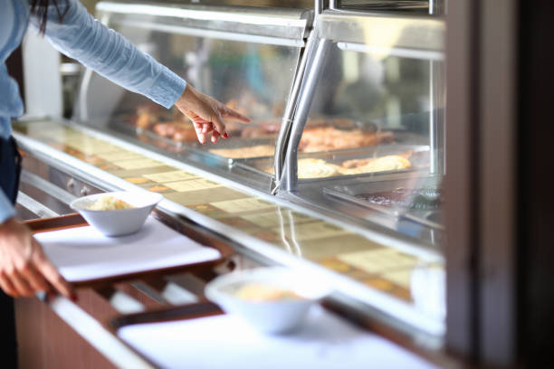 istock Woman in cafe points to dinner dish on salad tray. 1284897524